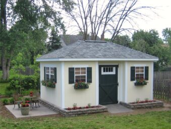 One of our custom sheds for sale in Dublin OH - Pale yellow siding - black doors and shutters - white-frammed windows - gray roof